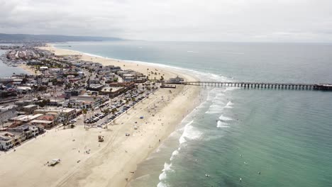 AERIAL:-Drone-shot-of-a-pier-at-the-beach-in-California