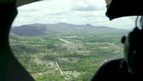 Airplane-cockpit-view-approaching-runway-in-rural-Costa-Rica,-Aerial-cockpit-handheld-view