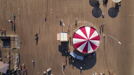 Top-down-view-of-the-horse-carousel-in-Tel-Aviv-port-while-people-walked-around-#016