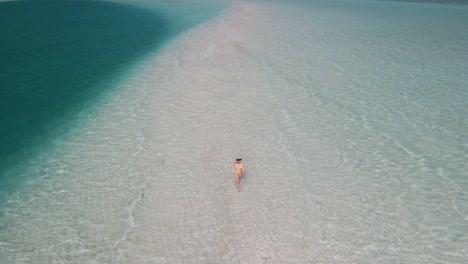 Orbit-shot-of-girl-walking-on-the-beach-in-Rasdhoo-island-in-Maldives
