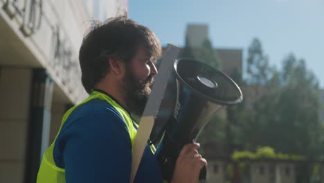 A-Man-Strike-Leader-Holds-a-Megaphone-and-Talks-to-an-Organizer-at-the-UC-Academic-Workers-Strike-on-UCLA's-Campus