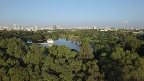 Push-in-reveal-over-the-trees-to-the-lake-in-Ramat-Gan-National-Park,-Israel-#006