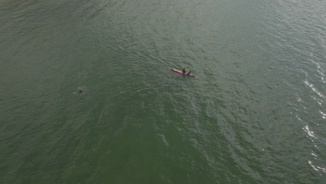 Aerial-Drone-shot-of-canoe-sailing-in-Hong-Kong-waters,-China
