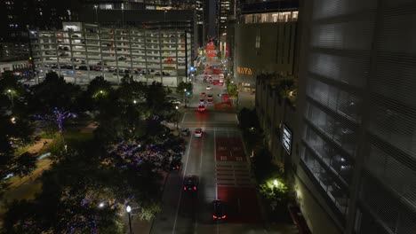 Aerial-view-following-traffic-on-the-Milam-street,-night-in-Houston,-Texas,-USA