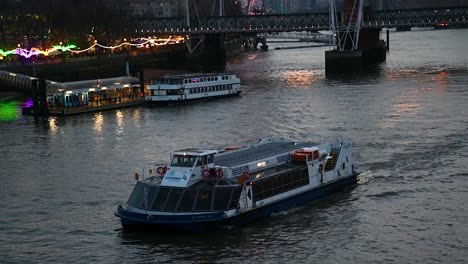 City-Crises-Sailing-towards-the-East-of-London-near-the-London-Eye,-Waterloo-Bridge,-United-Kingdom