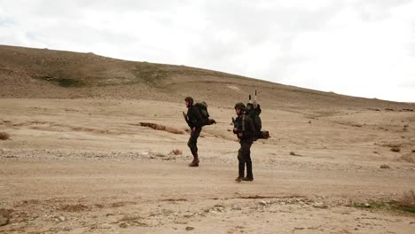 Two-IDF-Soldiers-Walk-in-a-war-training-area,-Israel