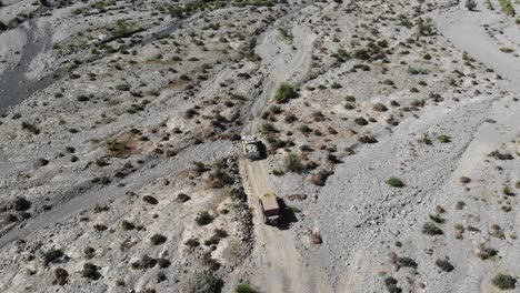 Aerial-back-shot-of-cars-driving-in-the-mountain