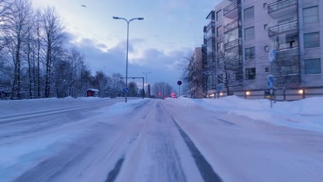 POV-driving-shot-through-downtown-Helsinki-and-stopping-at-traffic-lights