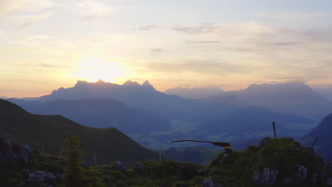 Aerial-view-across-sunrise-silhouetted-kitzbüheler-horn-mountain-in-panoramic-Tyrol-alps-mountain-range