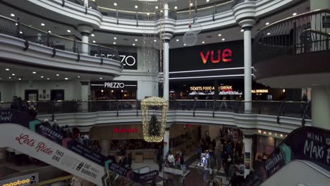 17-December-2022---Inside-View-From-St-Georges-Shopping-Centre-In-Harrow-With-Hanging-Festive-Christmas-Decoration-From-Ceiling