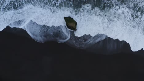 Luftaufnahme-Von-Oben-Nach-Unten-Von-Wellen-Des-Ozeans,-Die-Gegen-Den-Stapavík-seestapel-In-Island-Spritzen
