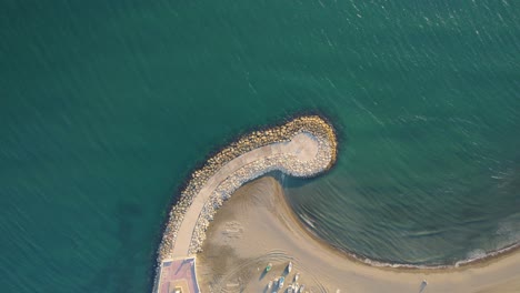 Graphic-top-view-smooth-drone-shot-above-seashore-in-candado-Malaga,-Spain