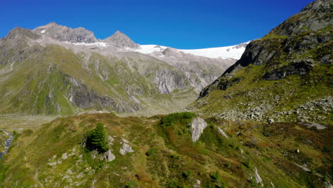Zillertal-alps-aerial-view-towards-steep-alpine-valleys-and-snow-capped-mountain-range