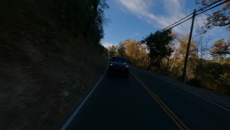 Backward-FPV-shot-of-a-police-car-traveling-through-the-countryside
