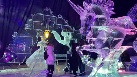 People-visiting-carved-ice-sculpture-festival-in-Madrid,-Spain