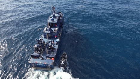 Aerial-shot-of-a-police-patrol-boat-and-next-to-the-boat-is-a-speedboat-also-from-the-police