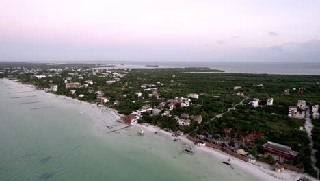 Drone-tilt-shot-of-housing-on-the-beach