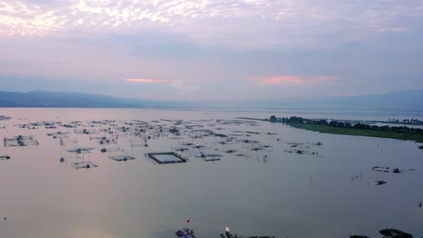Drone-view-of-Lake-with-fish-cage-in-sunrise-sky