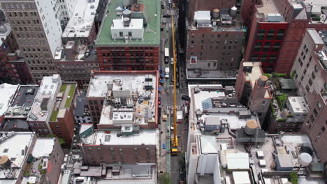 Aerial-View-of-Lower-Manhattan,-New-York-USA-and-Crane-on-Streets-in-Residential-Neighborhood,-Drone-Shot