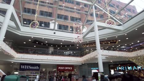 17-December-2022---Pan-Left-View-Of-Festive-Decorations-Hanging-From-Giant-Skylight-Inside-St-Anns-Shopping-Centre-In-Harrow