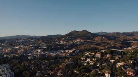 Aerial-forward-moving-drone-shot-over-El-Candado-hills-in-Malaga-Spain
