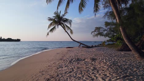 Girl-lying-alone-on-beach-under-palm-trees