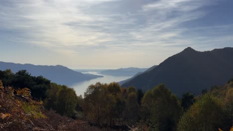 Panoramic-panning-view-of-Lake-Maggiore-seen-from-Monte-Carza-mountaintop-viewpoint,-zoom-in