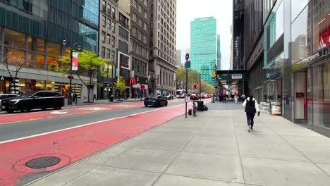 Walking-in-Midtown-Manhattan,-New-York-City-USA,-People-on-Sidewalk-and-Street-Traffic
