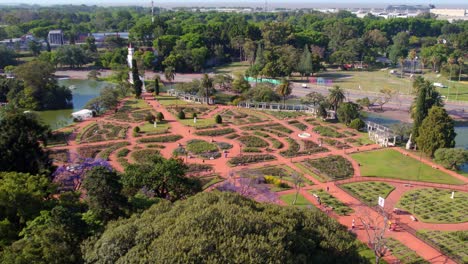 Aerial-view-dolly-in-the-Palermo-Rose-Garden-hidden-among-trees-in-springtime-in-Buenos-Aires,-Argentina