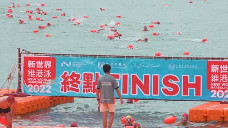 Los-Participantes-Llegan-Y-Cruzan-La-Línea-De-Meta-Durante-La-Competencia-Anual-De-Natación-New-World-Harbour-Race-En-Hong-Kong