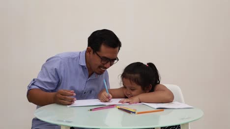 Indonesia---Dec-18,-2022-:-Cute-asian-little-girl-coloring-a-book-with-his-dad
