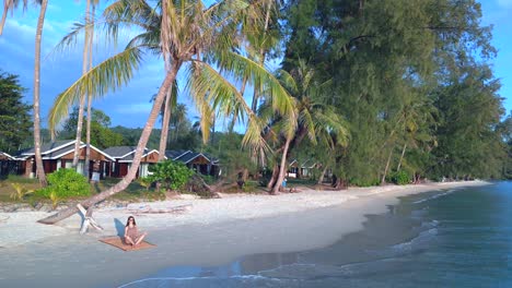 Tranquil-aerial-view-flight-circle-drone-footage
yoga-girl-palmtree-koh-kood-sunset-seacret-beach-thailand,-day-2022