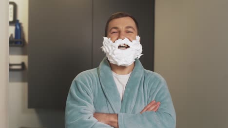 cheerful-man-with-a-beard-made-of-shaving-foam-laughing-and-looking-into-the-camera