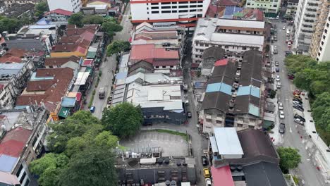 Top-view-of-shops,-houses,-streets-and-vehicles-in-Changkat-Bukit-Bintang,-Kuala-Lumpur,-Malaysia