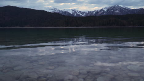 Calm-tranquil-Lake-Eibsee-transparent-rippling-water-under-alps-woodland-mountain-range-Bavaria