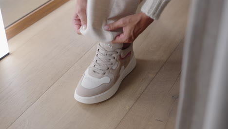 CloseUp-of-woman-putting-on-beige-shoes-in-store-cabin