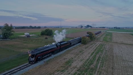 An-Aerial-View-of-a-Steam-Passenger-Train-Traveling-Thru-Farmlands-Blowing-Smoke-in-Slow-Motion