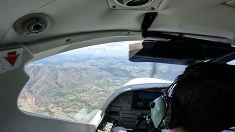 Turbulence-experienced-in-single-engine-airplane-over-farmland-countryside,-Cockpit-over-the-shoulder-view