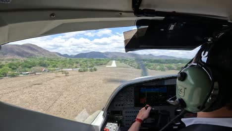 Single-engine-airplane-landing-on-jungle-landing-strip-runway-with-turbulence,-Cockpit-view