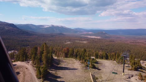 Gimbal-static-shot-from-gondola-passing-over-ski-lifts-on-Mammoth-Mountain-in-California-during-the-summer