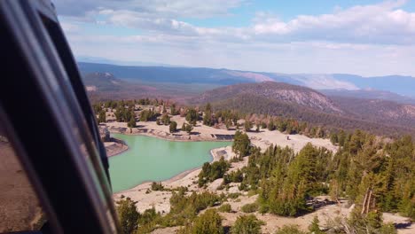 Gimbal-static-shot-from-gondola-looking-forward-towards-a-pond-as-it-descends-down-Mammoth-Mountain-in-California