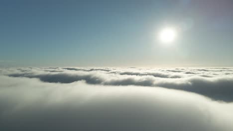 Vista-Of-Fluffy-Bed-Of-Clouds-Illuminated-By-Afternoon-Sunlight