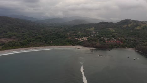 Approaching-Playa-Carrillo-Beach-and-resorts-in-West-Costa-Rica,-Aerial-dolly-in-shot