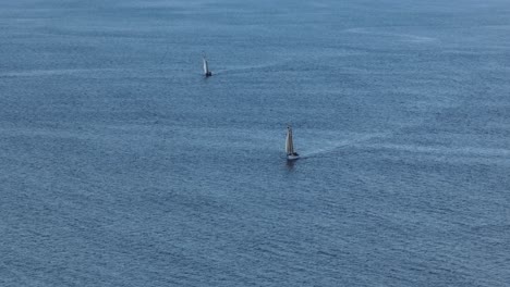 Sailboats-sailing-across-the-open-sea-Slow-motion-aerial