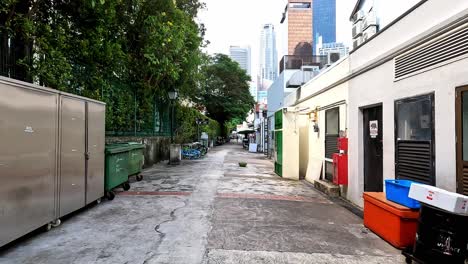 Empty-Business-Alleyway-with-Recycle-Bins,-Singapore,-POV-view