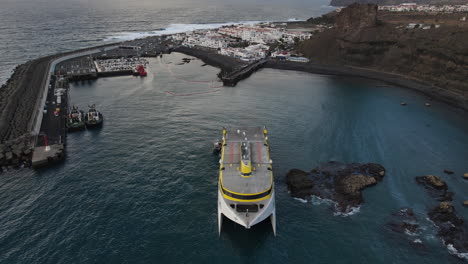 Aerial-shot-of-a-stranded-ferry-near-the-dock-of-the-port-of-Agaete-and-where-remains-of-fuel-are-shown