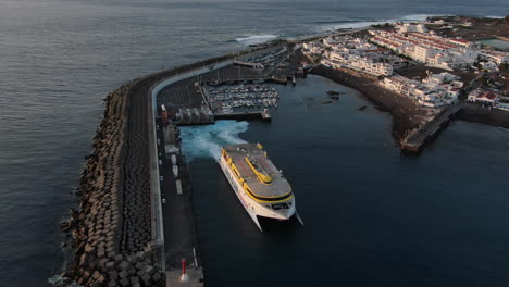 Fantastic-aerial-shot-of-a-ferry-leaving-the-port-of-Agaete-during-sunset