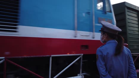 Early-morning-diesel-passeger-train-passes-through-Saigon-streets-at-a-level-crossing