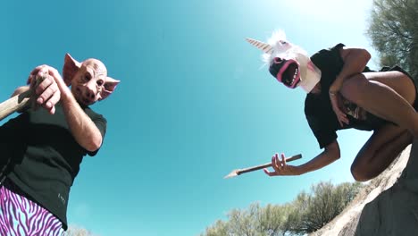 Two-killers-in-horse-and-pig-masks-pose-threateningly-with-axes-and-shovels