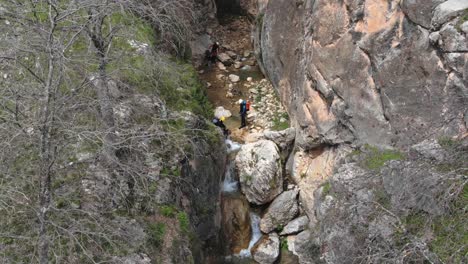 Canyoning-inside-a-ravine-right-next-to-a-precipice-and-waterfall